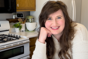 woman smiles in her kitchen