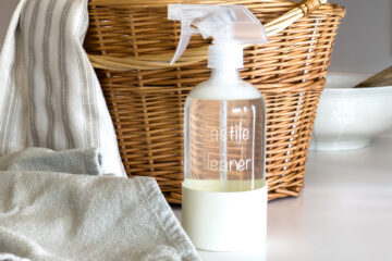 a bottle of Castile Cleaner spray sits on the counter next to a cleaning cloth