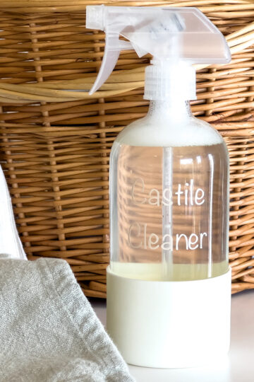a bottle of Castile Cleaner spray sits on the counter next to a cleaning cloth