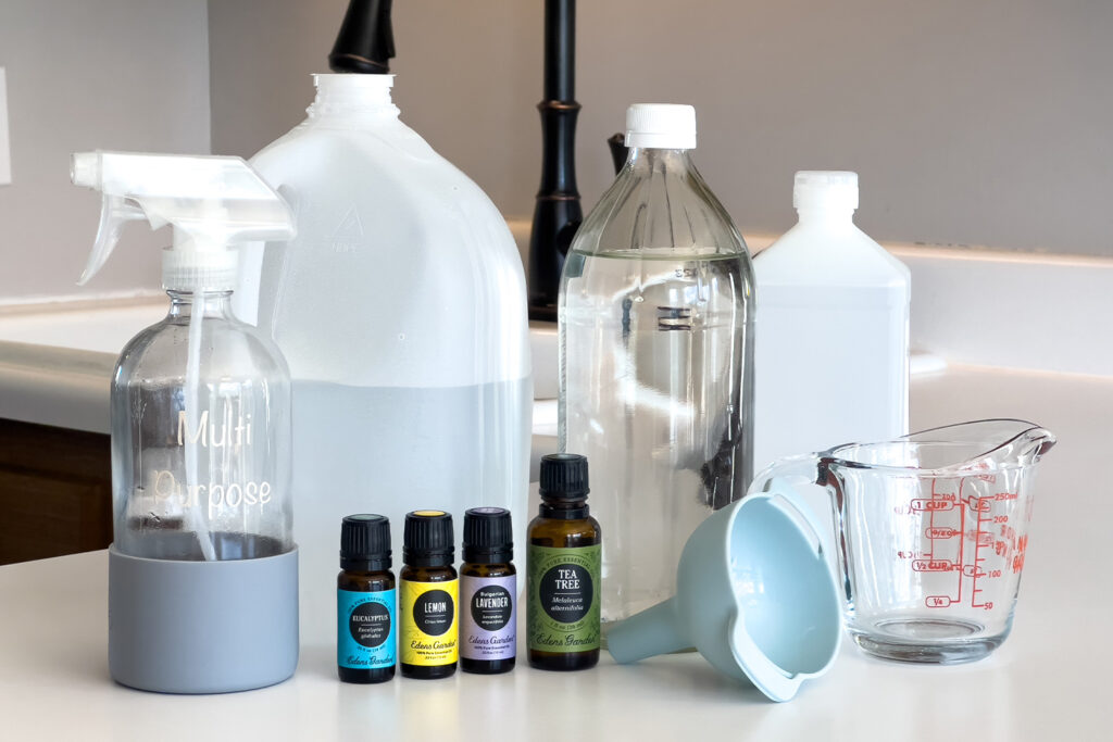 vinegar, rubbing alcohol, water, essential oils, and a spray bottle for how to make a multi purpose cleaning spray