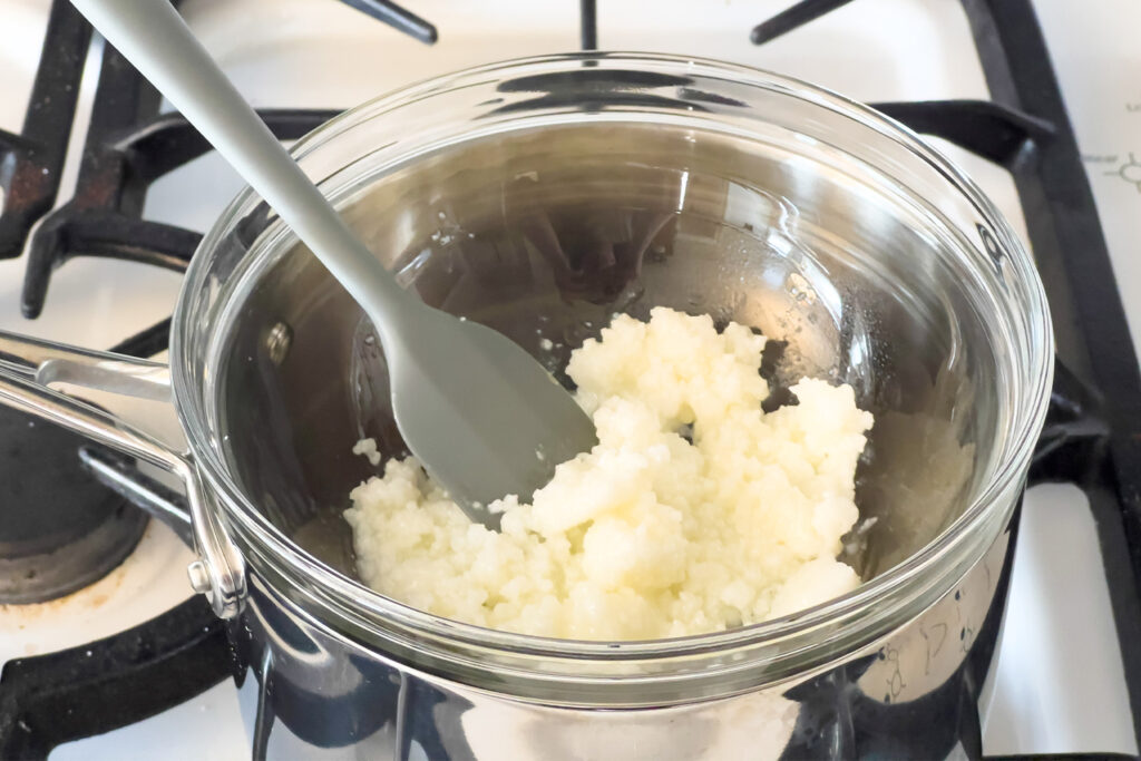 a pot of shea butter is being heated on the stovetop