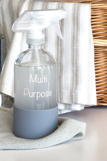 diy multi purpose spray sitting on a cleaning rag in the kitchen