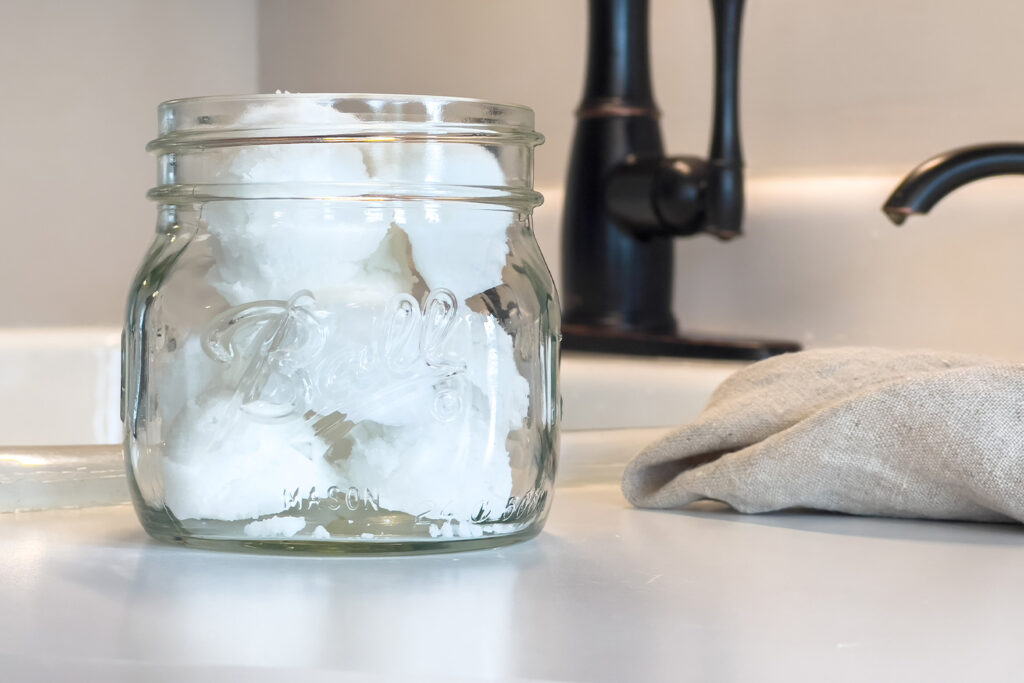 a jar of DIY garbage disposal cleaning pods sits on the counter