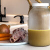 vegetable scraps, bone scraps, and bone broth sit on the counter