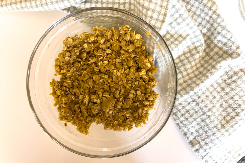 a bowl of crumble topping sits on the kitchen counter