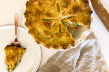 a slice of sourdough chicken pot pie sits next to the rest of the pie