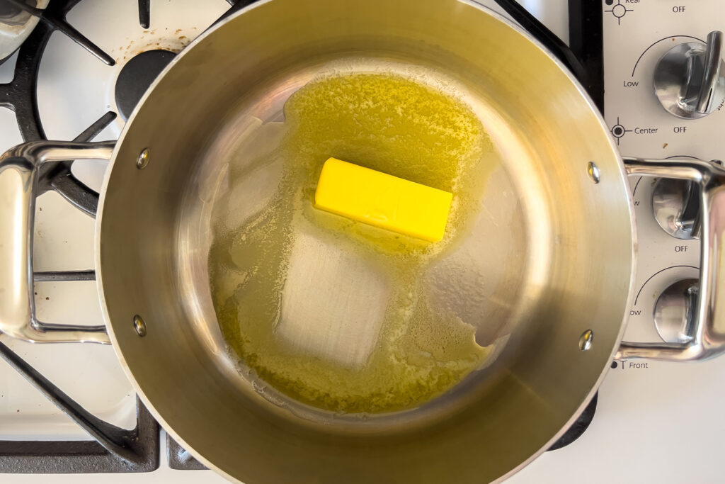 butter is melting in a pot on the stove