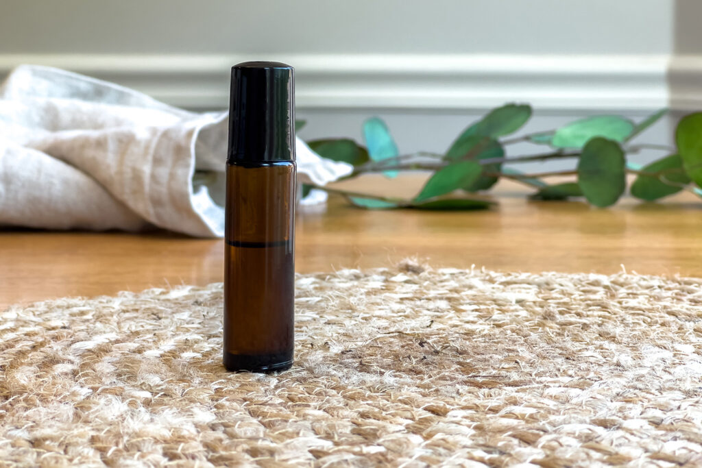 a roller bottle of homemade acne treatment sits on the counter