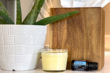 a jar of homemade chest rub for colds is sitting on the counter near tissues