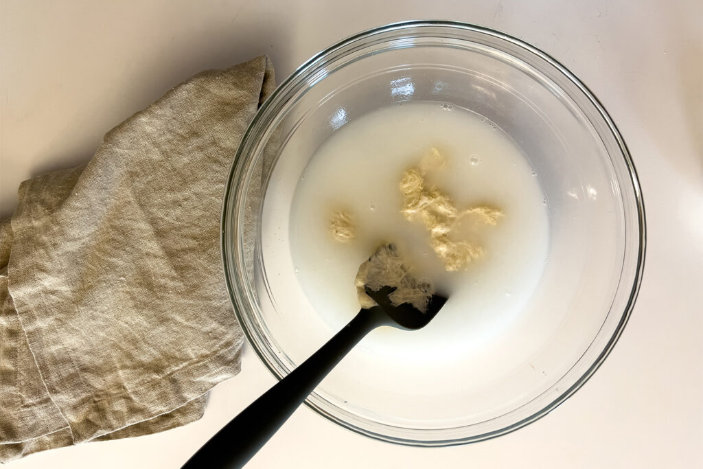 water and sourdough starter in a bowl