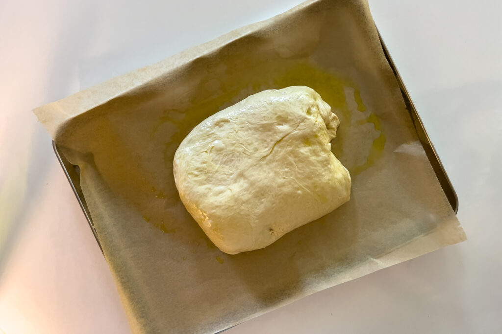 dough for sourdough focaccia in the middle of a pan