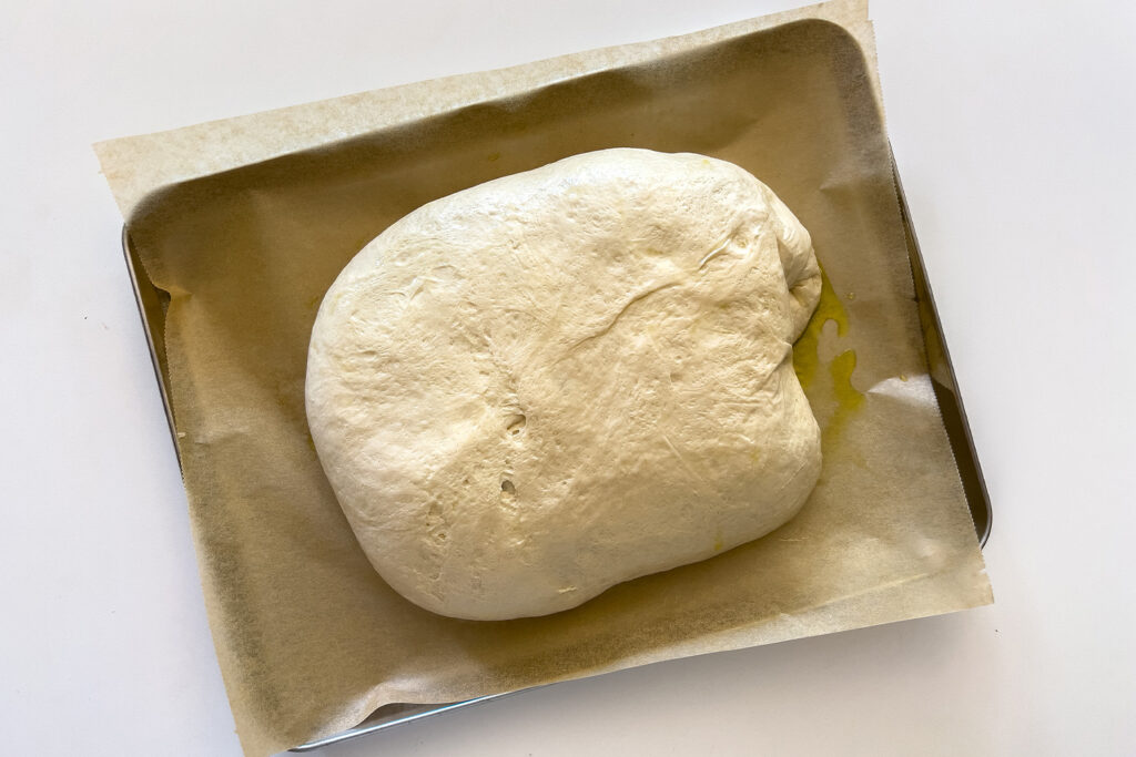 dough for sourdough focaccia in the middle of a pan
