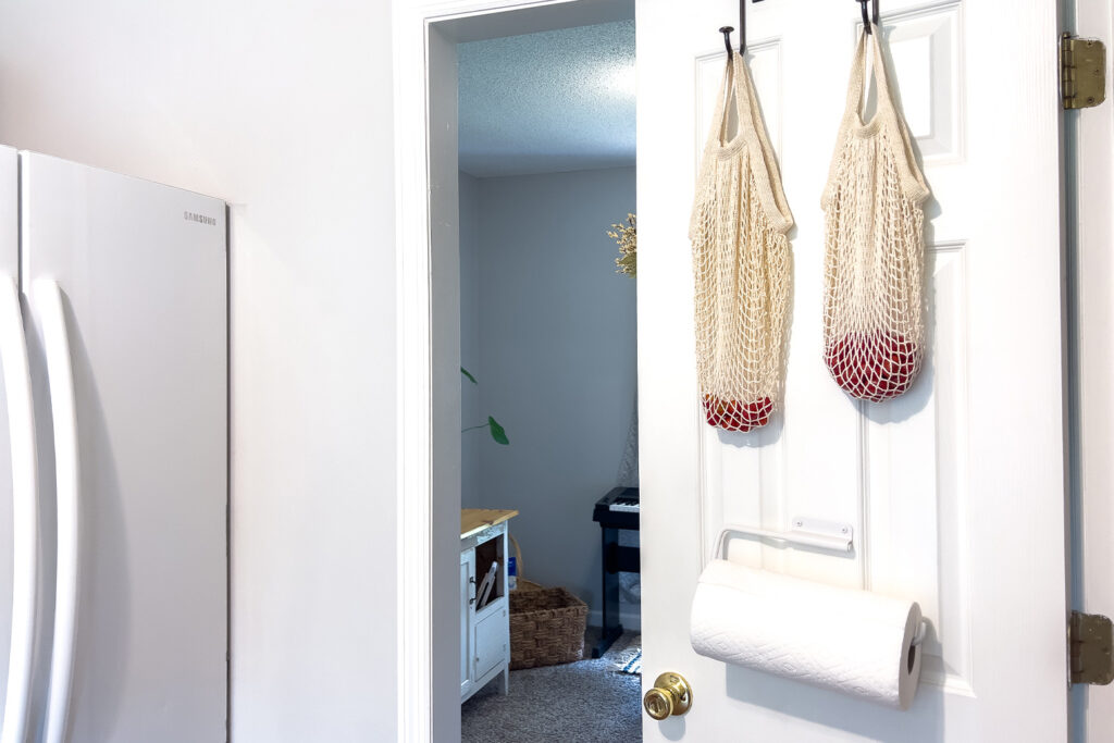 a roll of paper towels hanging on the door of a budget friendly pantry renovation