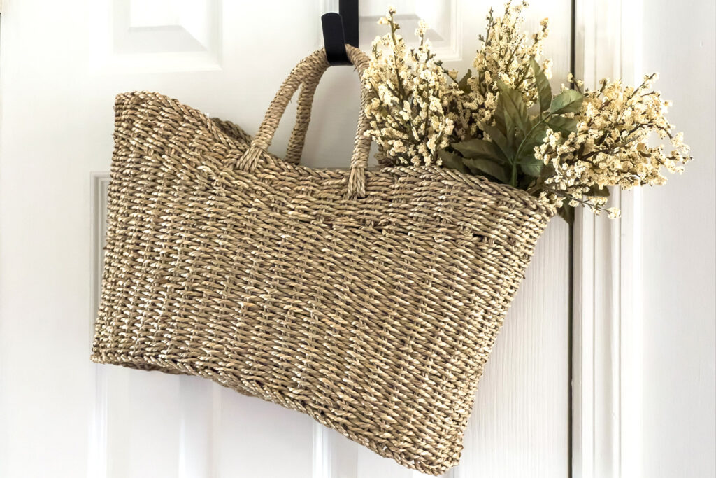 a basket full of faux stems hanging on the door