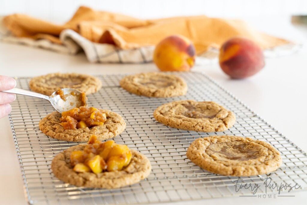 spooning filling into sourdough peach cobbler cookies