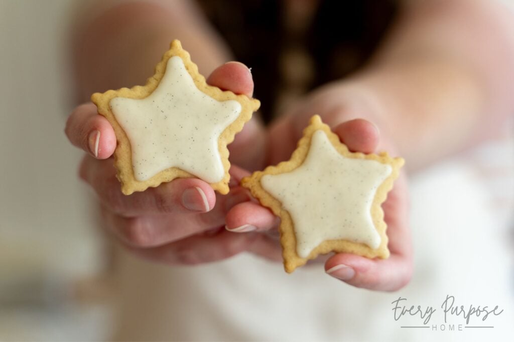 the sourdough cookie lady holding sourdough vanilla bean cookies with cut outs
