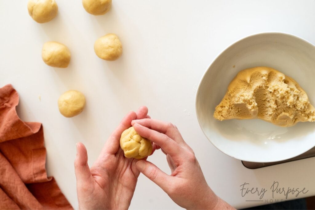 rolling sourdough cookie dough into balls