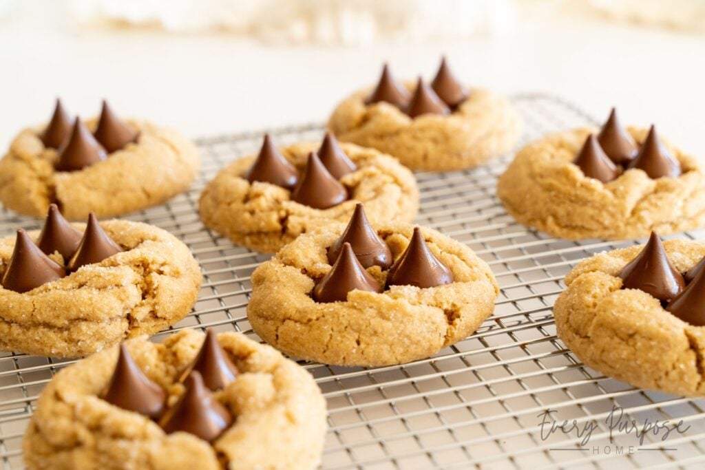 sourdough peanut butter kiss cookies with three kisses on cooling rack