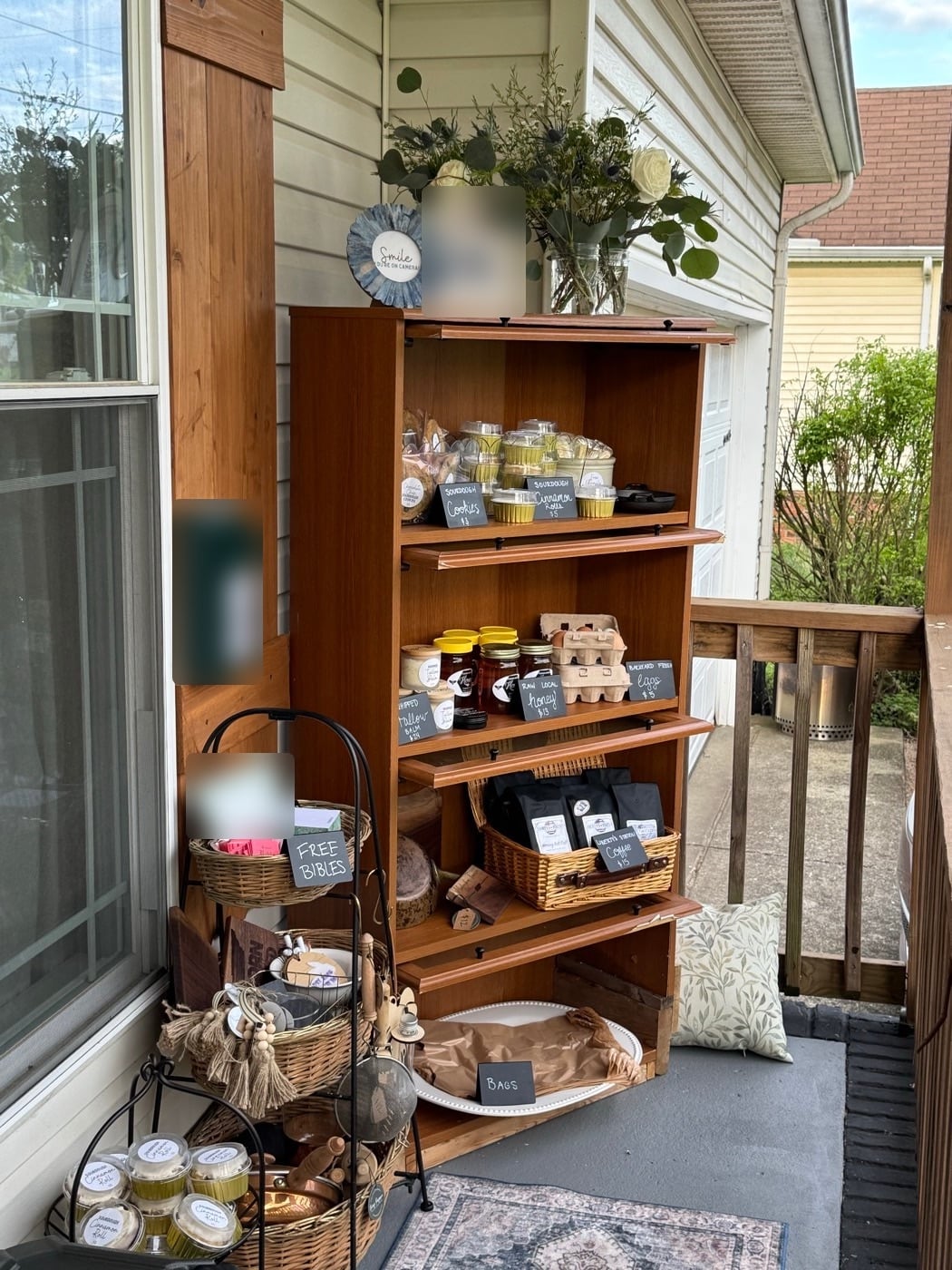Marlene’s porch farmstand shelves filled with sourdough cookies, cinnamon rolls, honey, and eggs