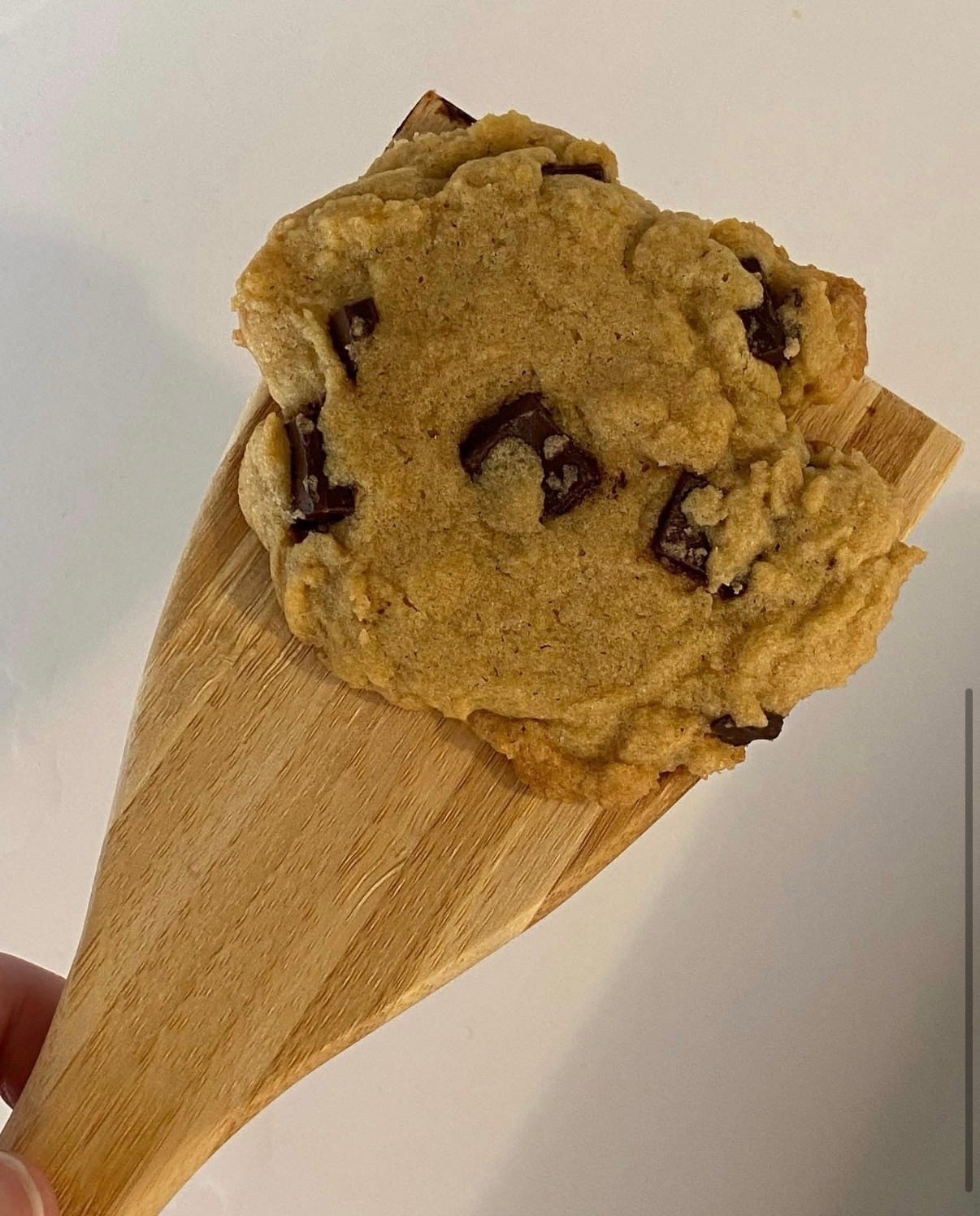 Marlene’s very first from-scratch chocolate chunk cookie on a wooden spatula, 2020