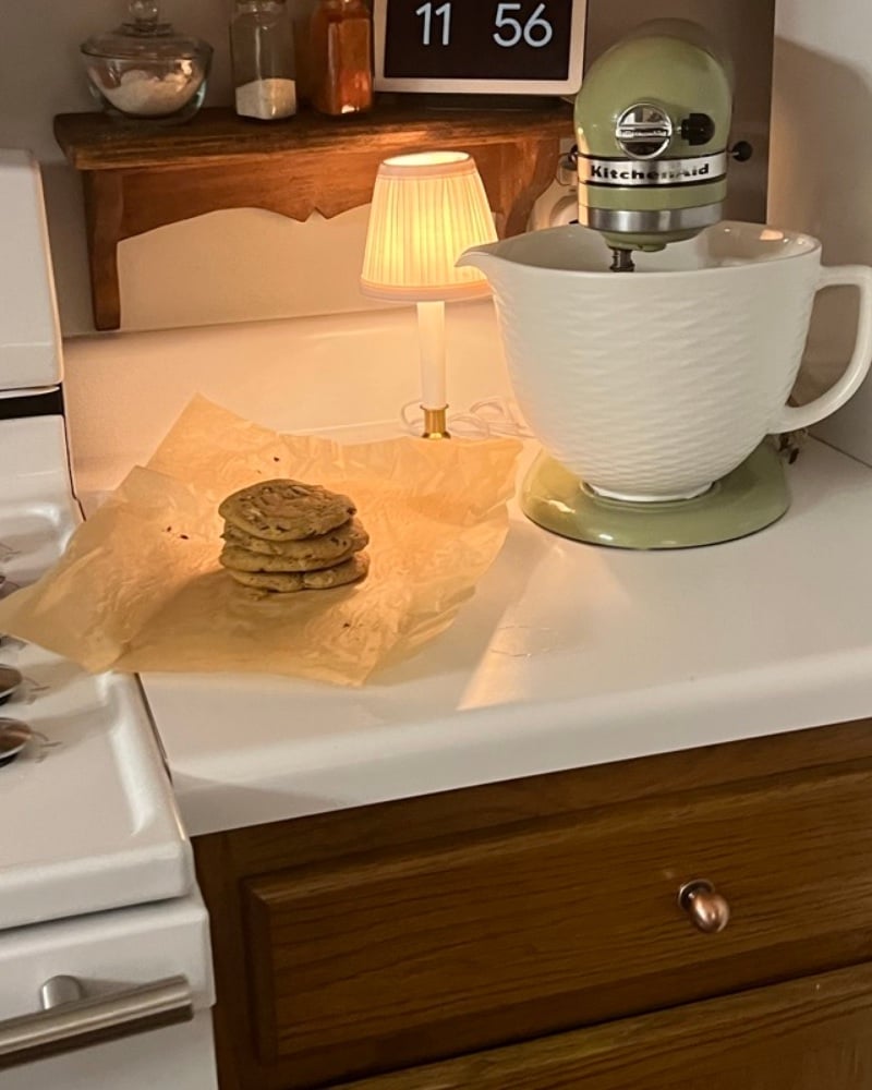 Marlene’s vintage green KitchenAid mixer on her kitchen counter beside a small lamp and a stack of sourdough cookies