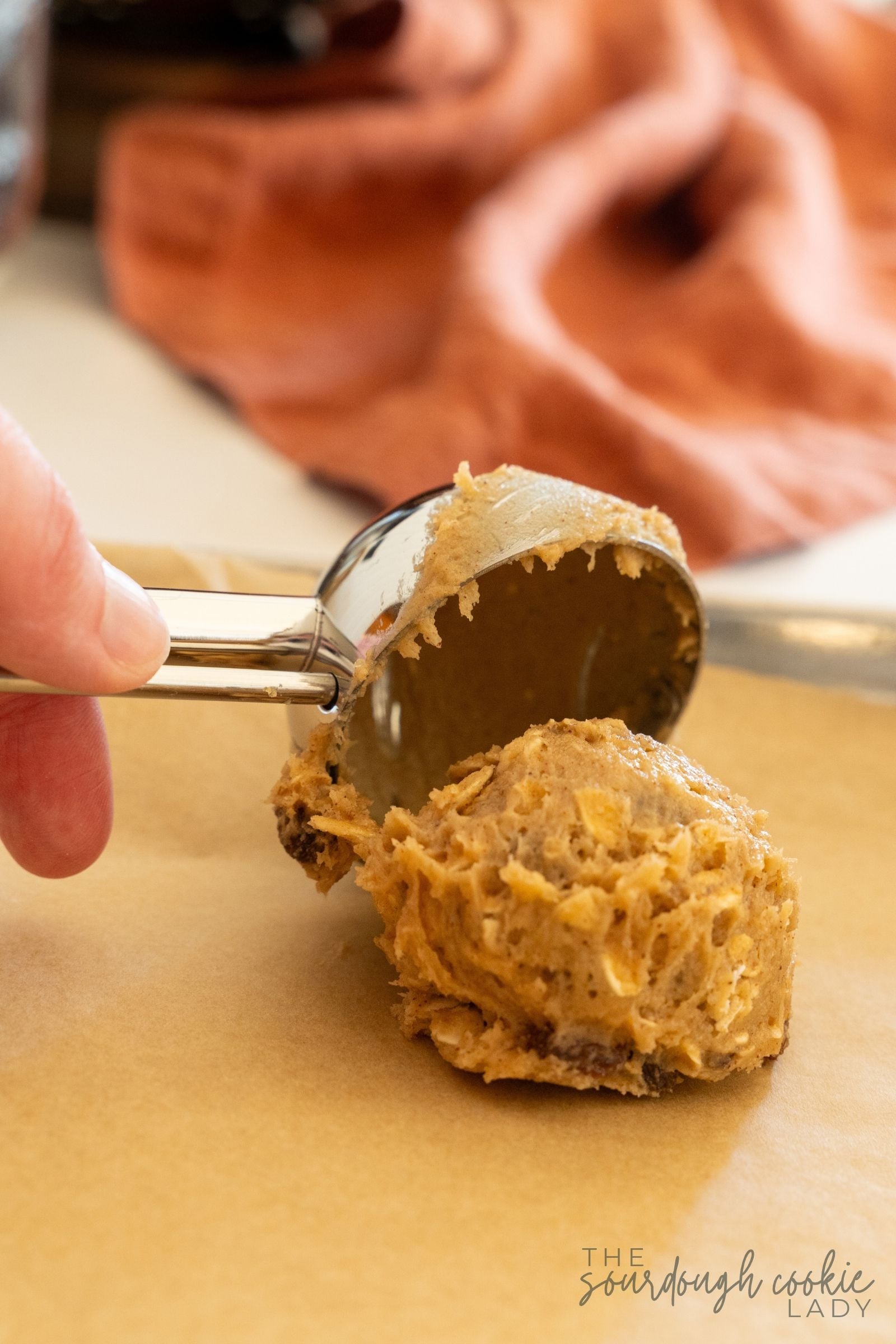 scooping sourdough oatmeal cookie dough