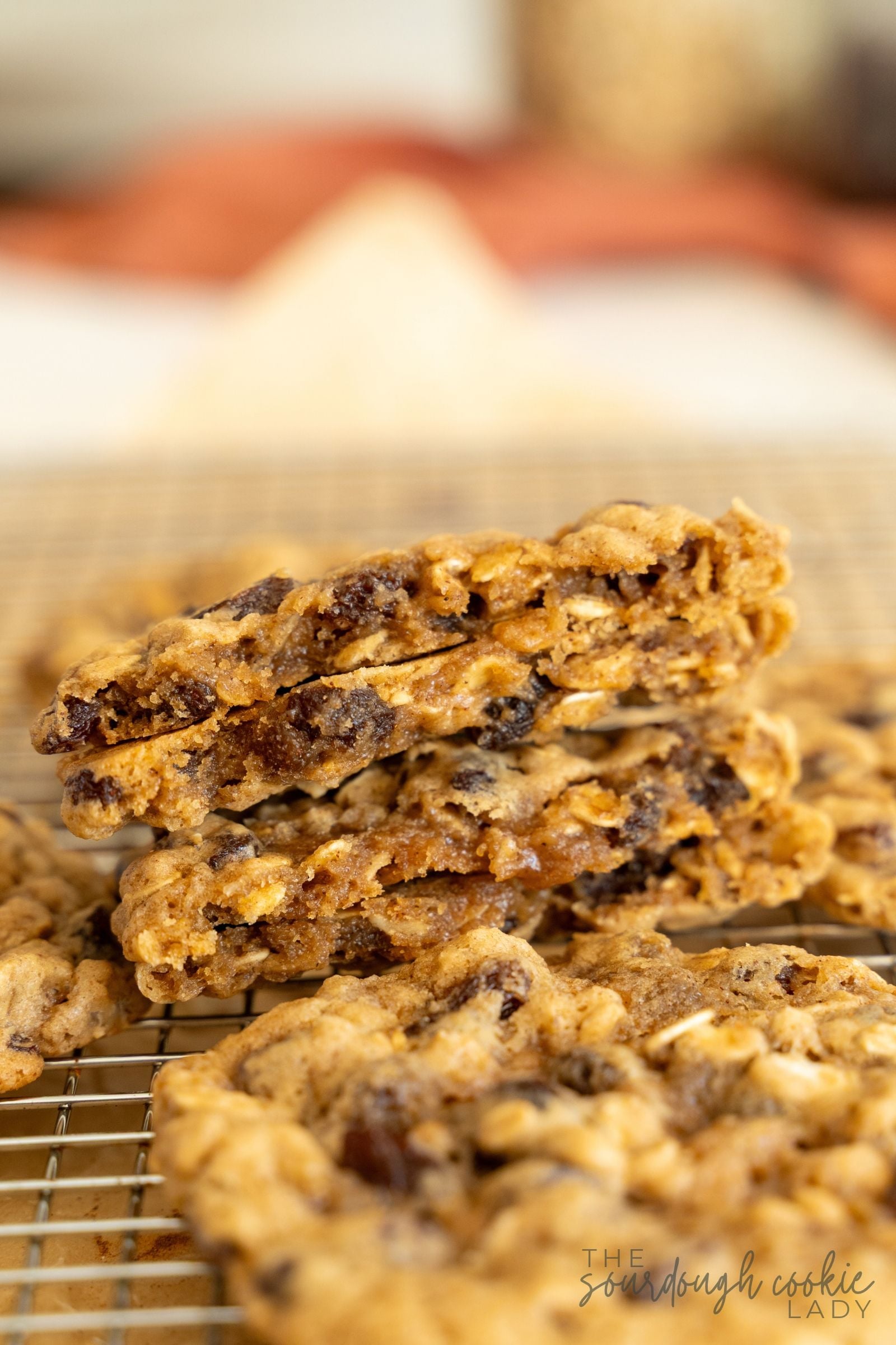 soft and chewy oatmeal raisin cookies broken in half on a cooling rack